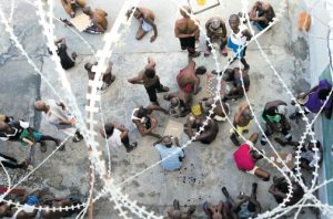 Some prisoners play dominoes, checkers or card games, during recreation time inside the National Penitentiary in downtown Port-au-Prince, Haiti. (Photo: AP)